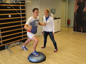 Cliënt voert oefening uit tijdens medische fitness onder begeleiding van fysiotherapeut